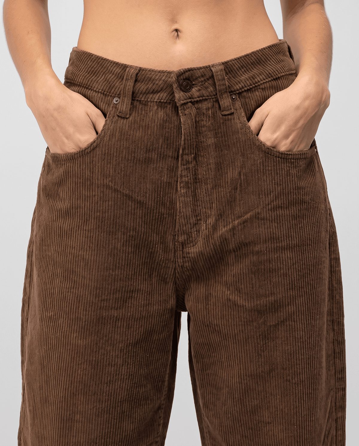 Close-up of the high button waist, belt loops and scoop front pockets on ribbed fabric