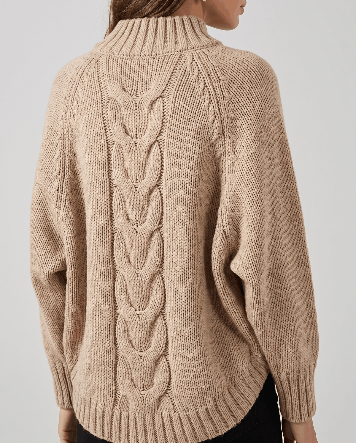 Back view of light tan cable knit sweater with wide batwing sleeves