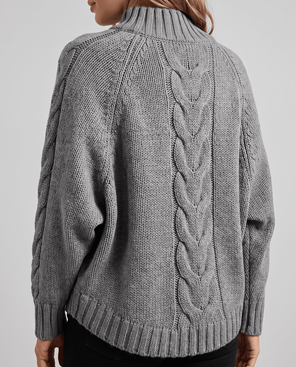 Back view of gray cable knit turtleneck showing center cable panel