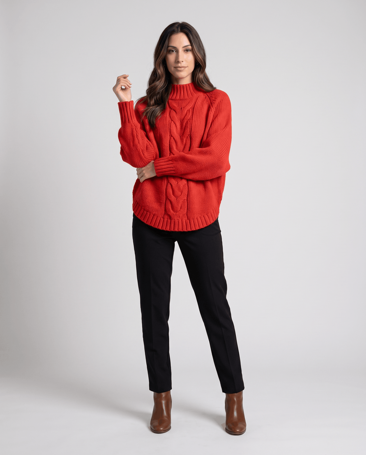 Full-length view of red cable knit turtleneck with black pants and brown boots