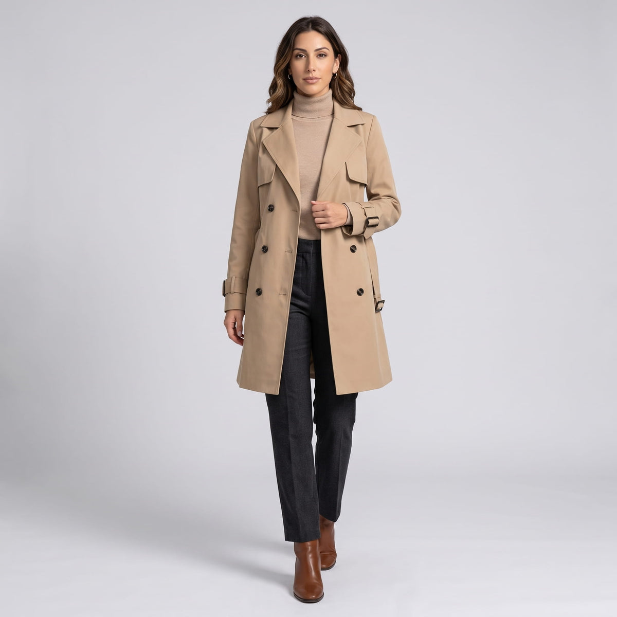 Full-length view of beige coat with black trousers and brown ankle boots
