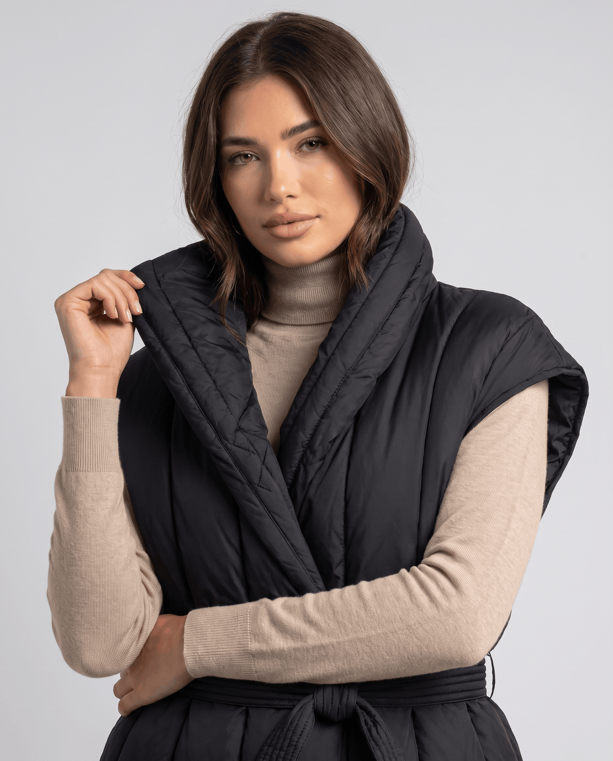 Close-up of black vest collar and quilting detail on the front
