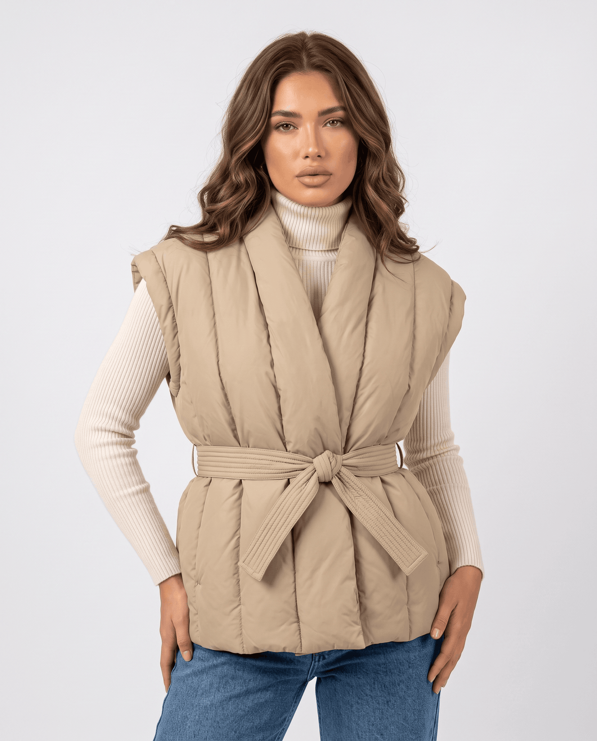 Model in khaki quilted vest with shawl collar and tie waist belt, front view