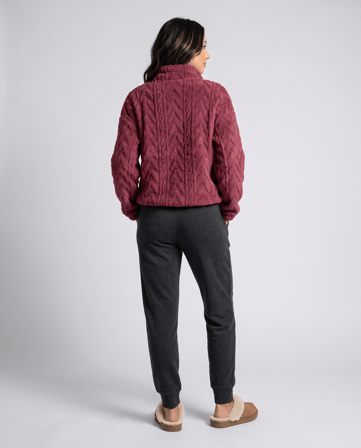 Full-length back view of burgundy pullover with charcoal joggers and slippers