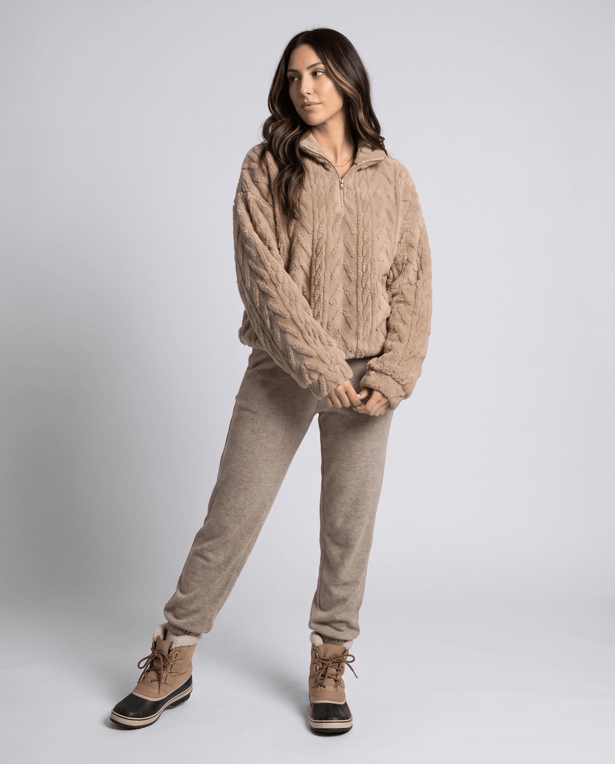 Full-length view of khaki pullover with matching joggers and lace-up boots