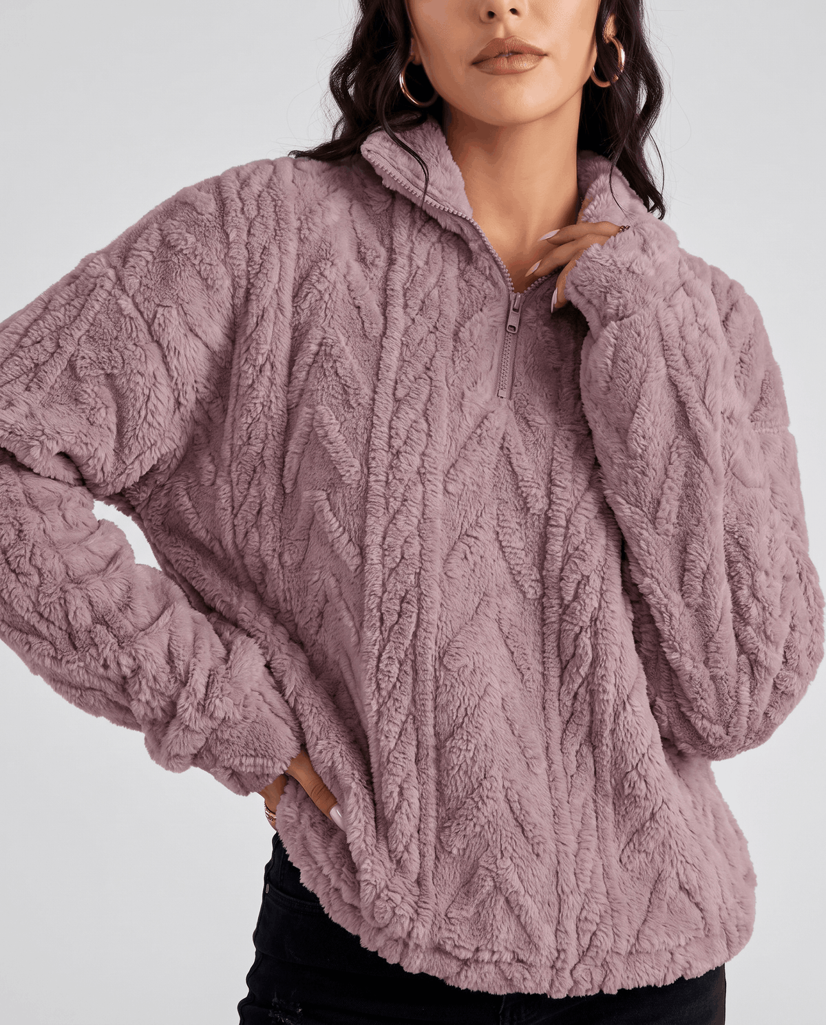 Side view of light purple cable-textured pullover showing ribbed cuffs