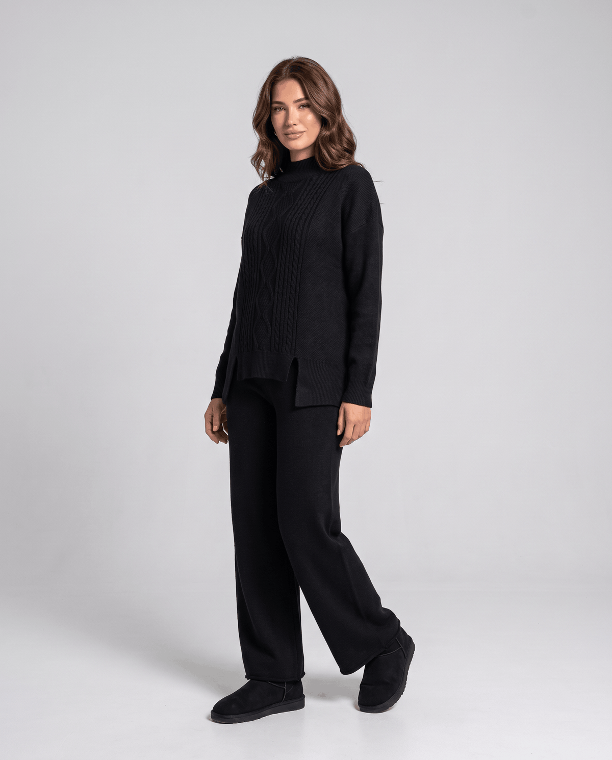 Black cable knit pullover with mock neckline and wide-leg pants, front view