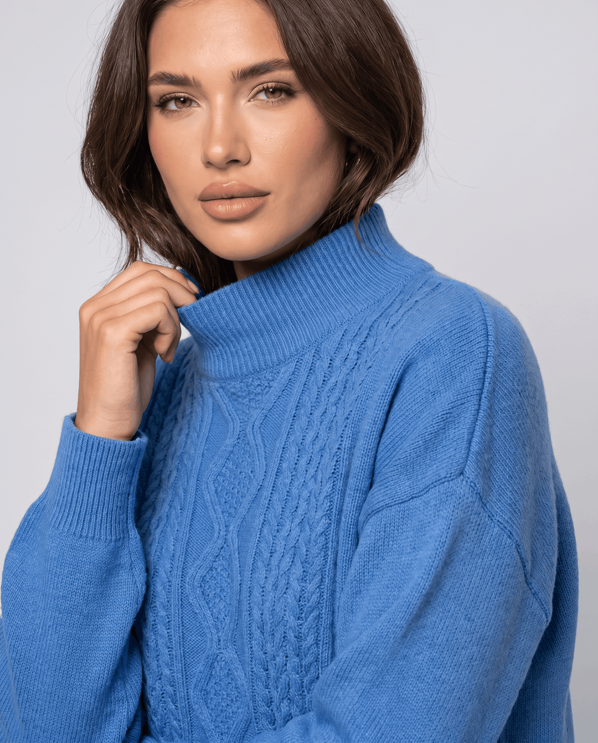 Close-up of the blue cable knit pullover and mock neckline