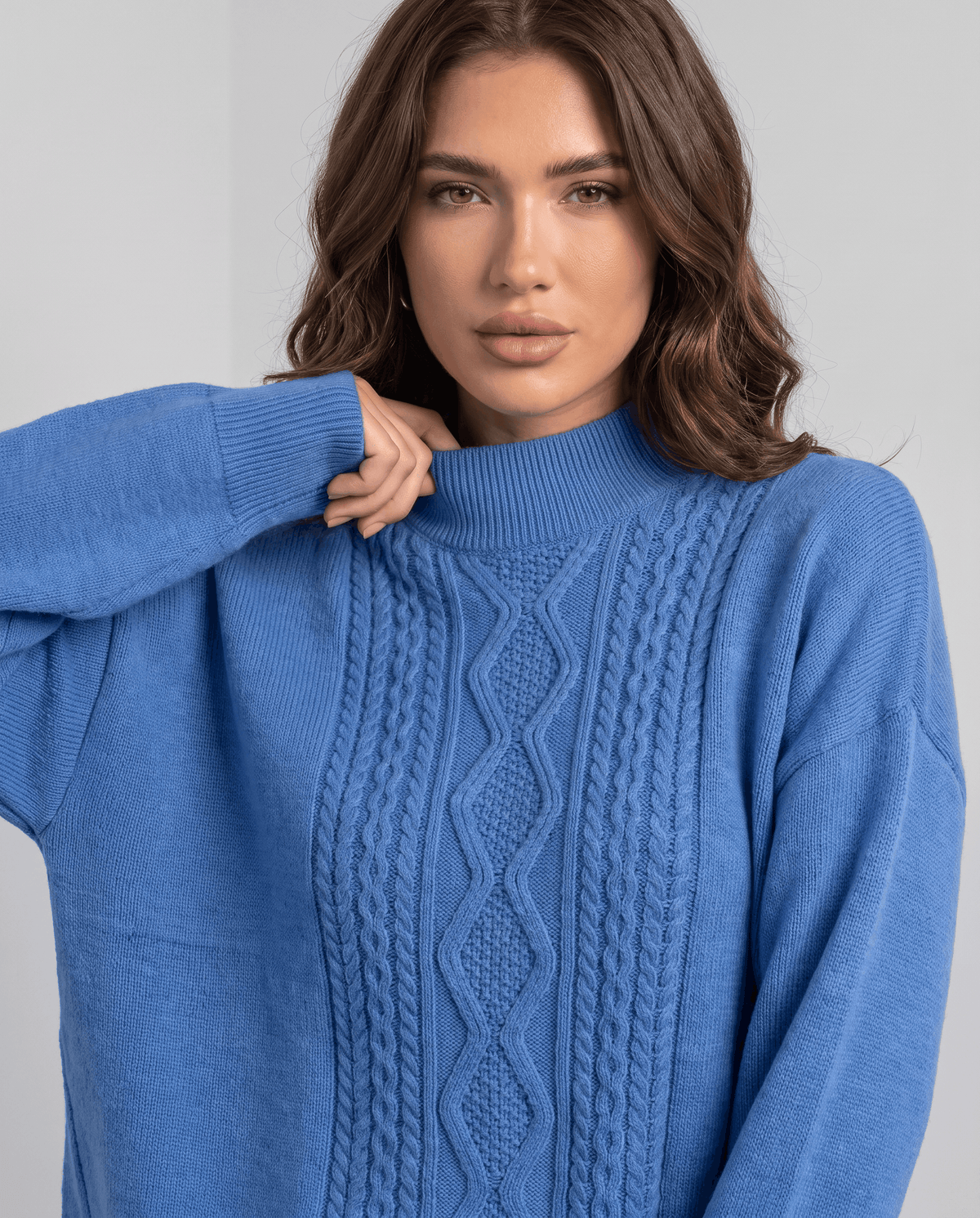 Close-up of the blue cable pattern down the front of the pullover