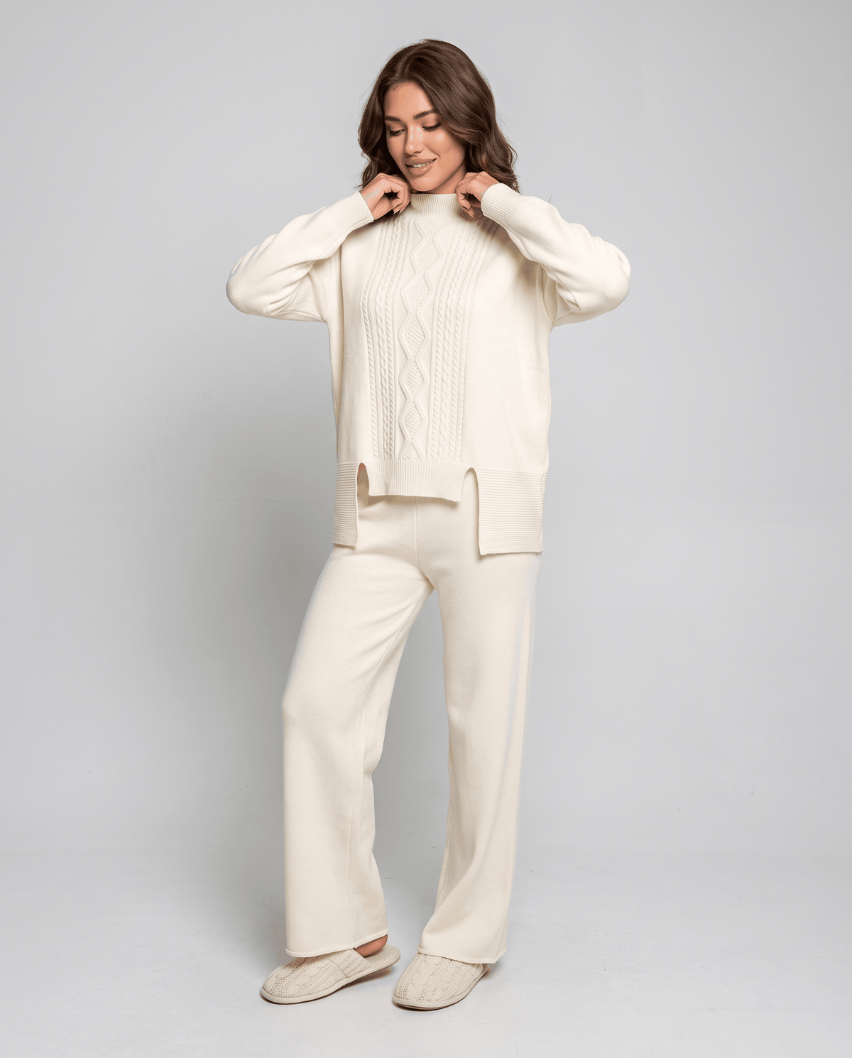 Cream cable knit pullover and wide-leg pants, front view