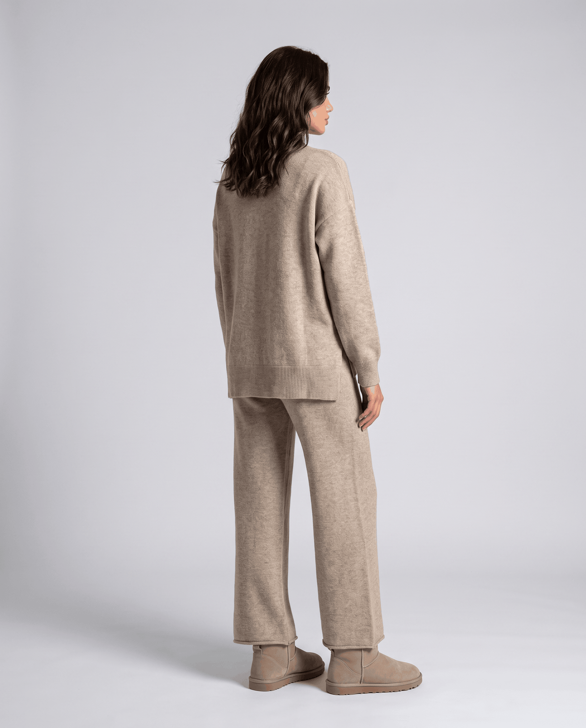 Back view of the khaki cable knit pullover and wide-leg pants