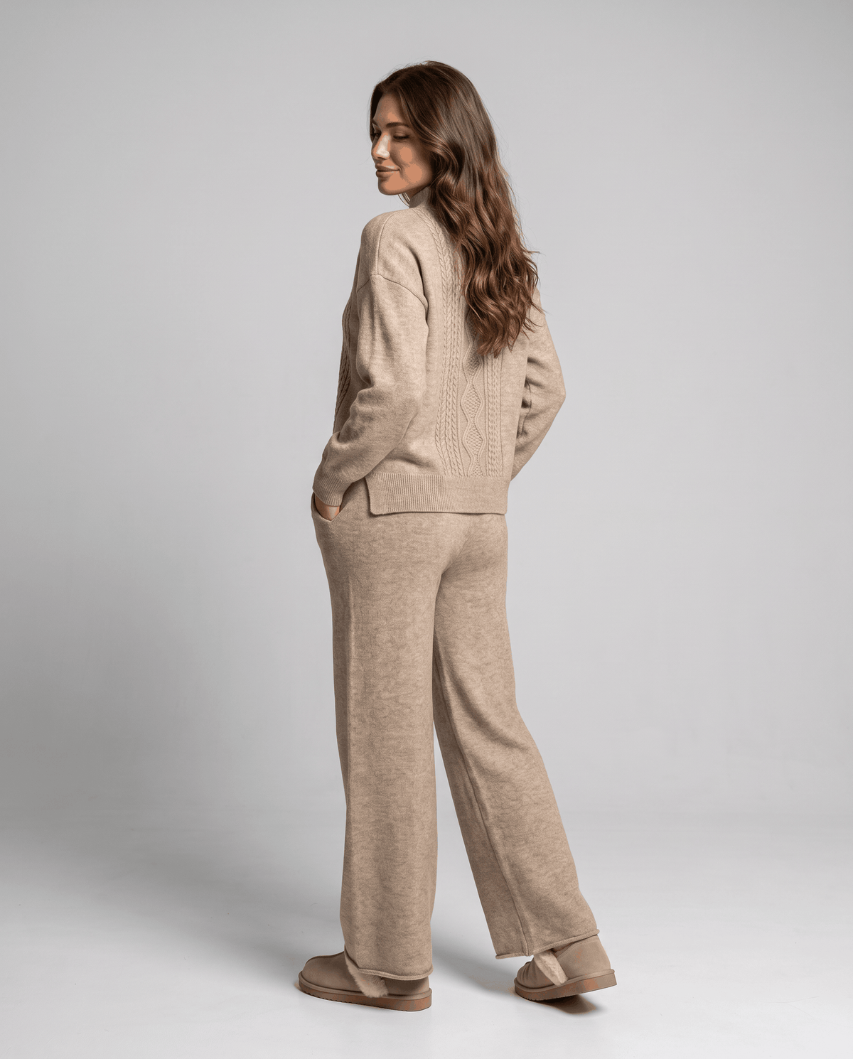 Side back view of the khaki cable knit pullover and wide-leg pants