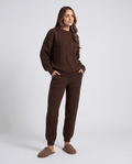 Woman wearing a brown cable knit loungewear set with crew neck sweater and jogger pants