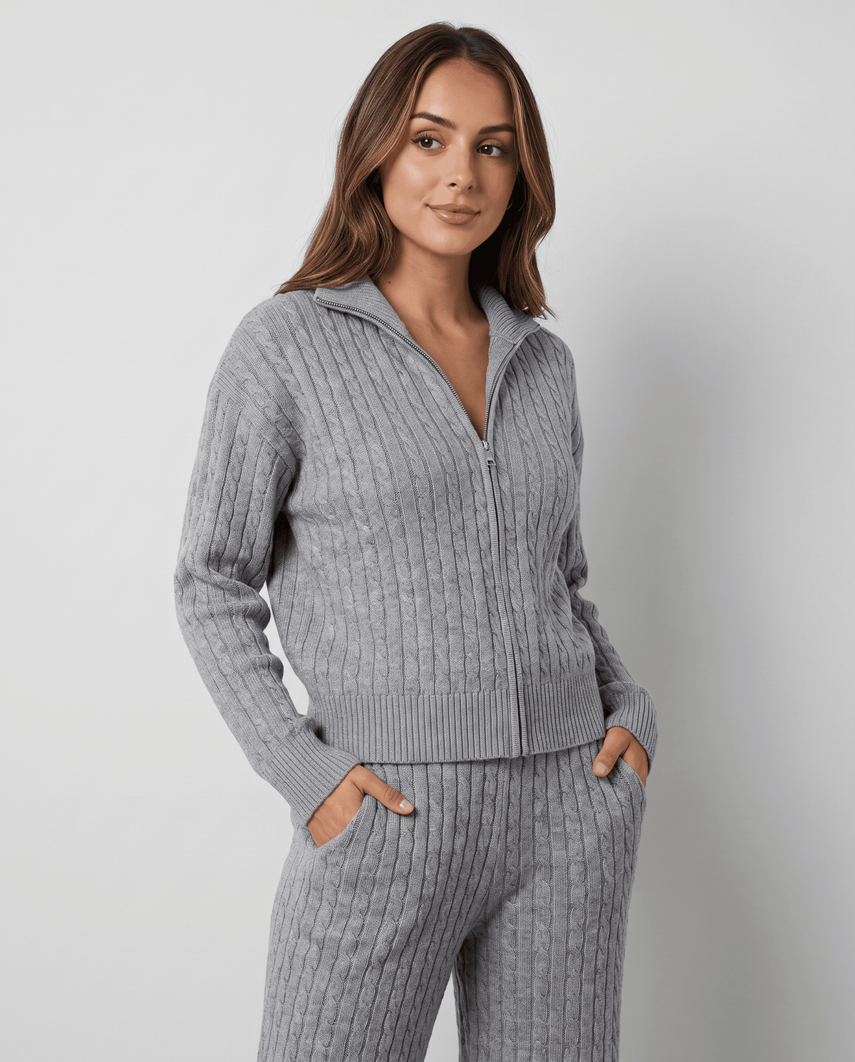 Close-up of the zip and collar on the gray cable-knit jacket