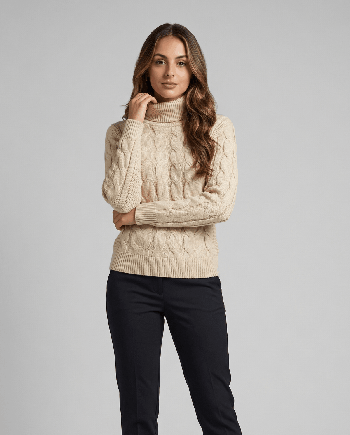 Beige turtleneck sweater styled with black trousers, standing front view in the studio