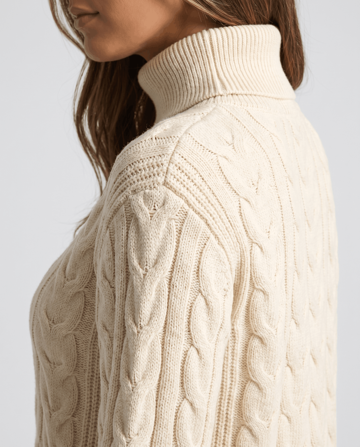 Side profile of the beige fold-over neck and textured cable sleeve