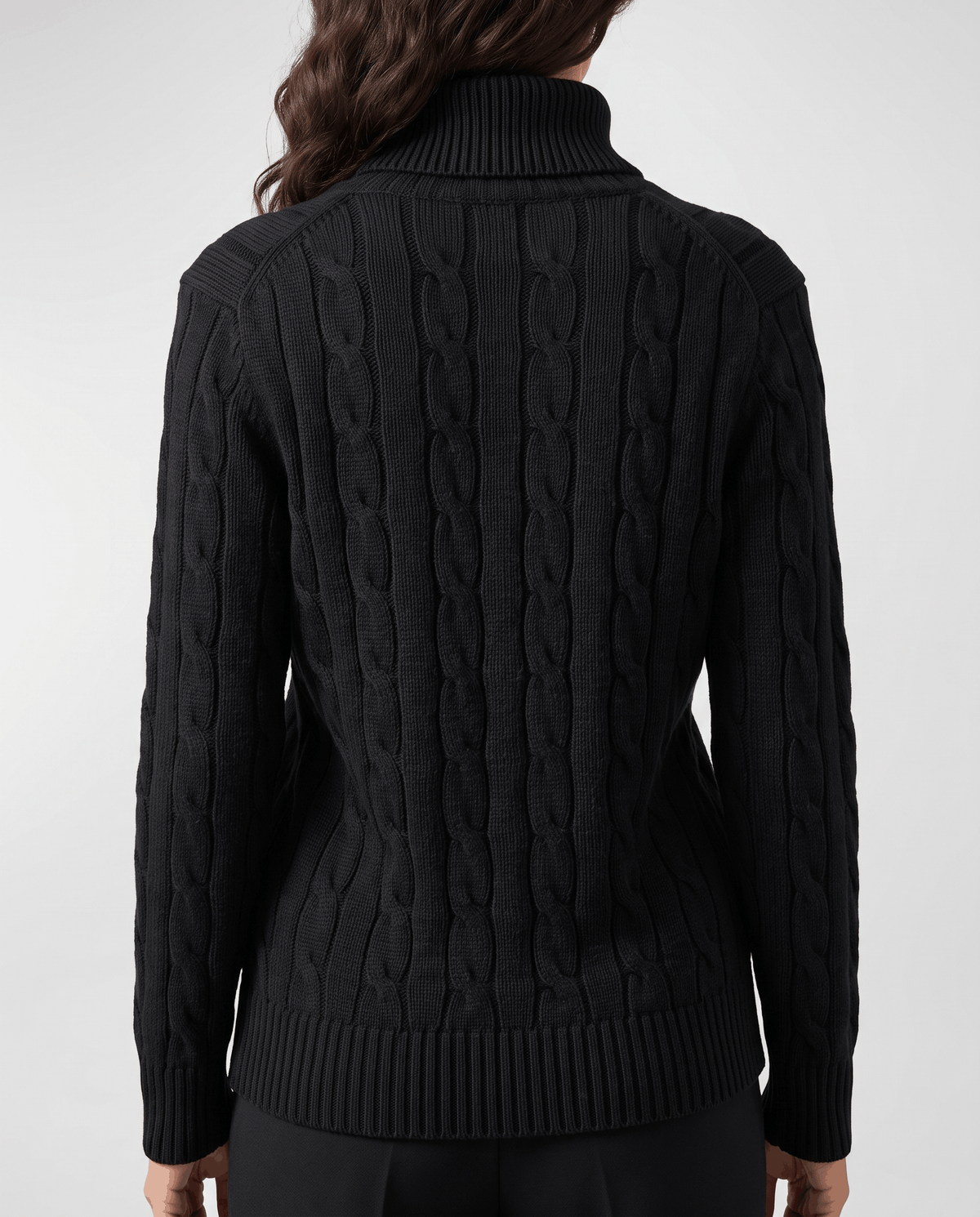 Back view of the black sweater with vertical cables and ribbed hem
