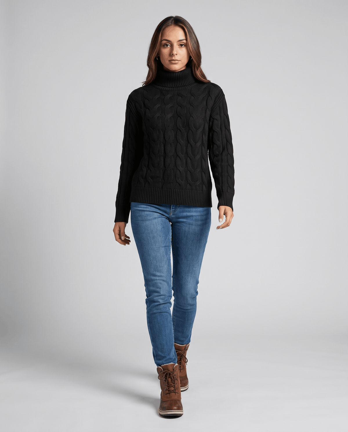 Full-length view of the black turtleneck with blue jeans and brown boots