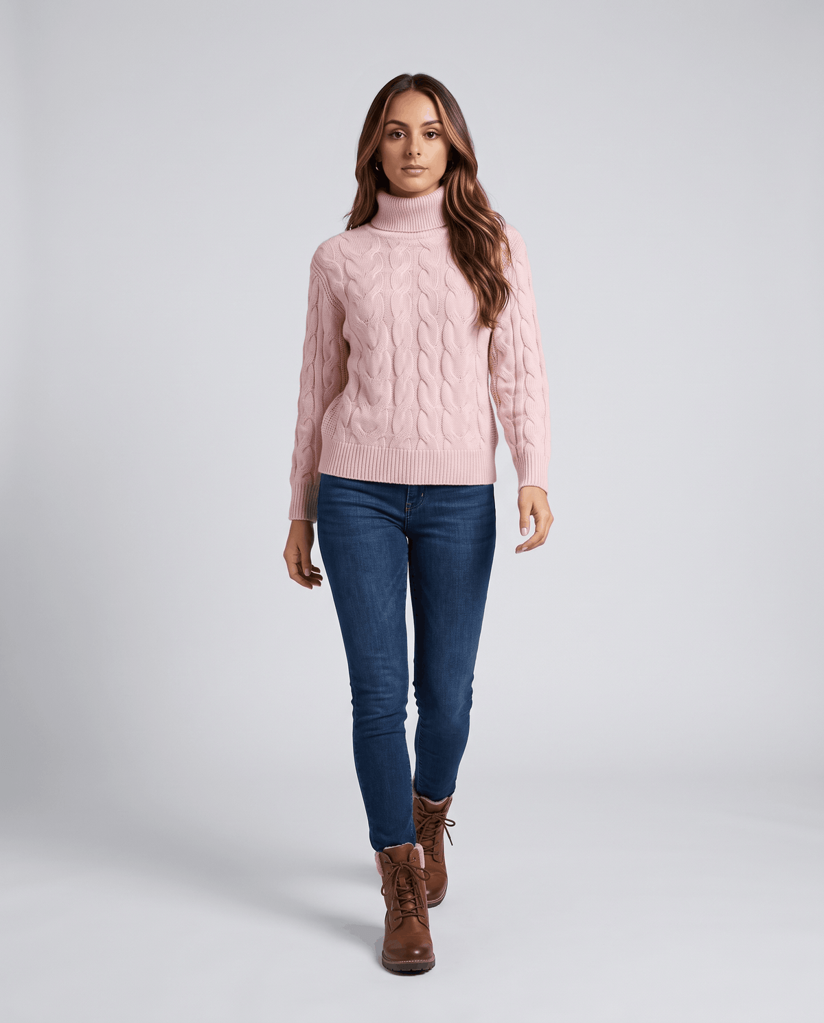 Full-length look in the pink turtleneck with slim jeans and brown ankle boots