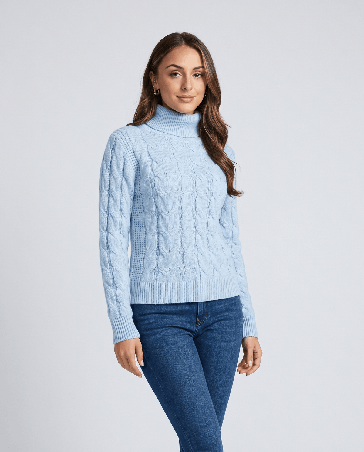 Sky blue turtleneck sweater worn with dark jeans, relaxed front view