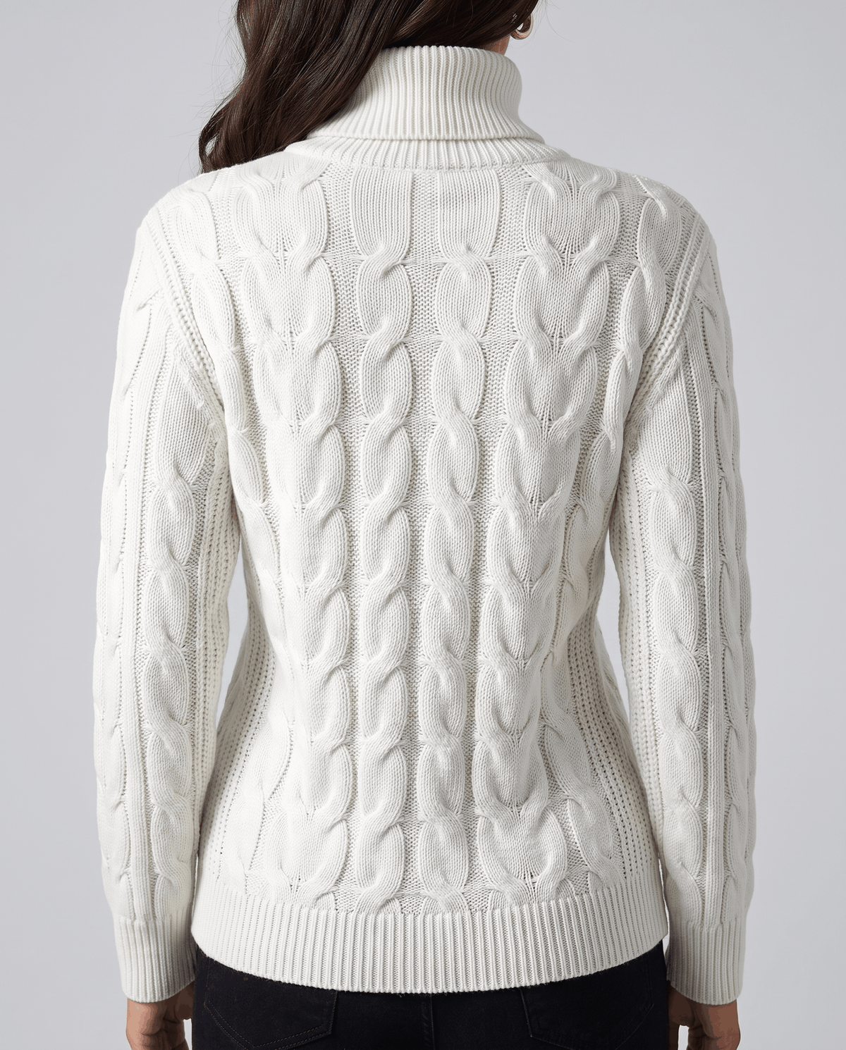 Back view of the white knit with cable panels and a ribbed waistband