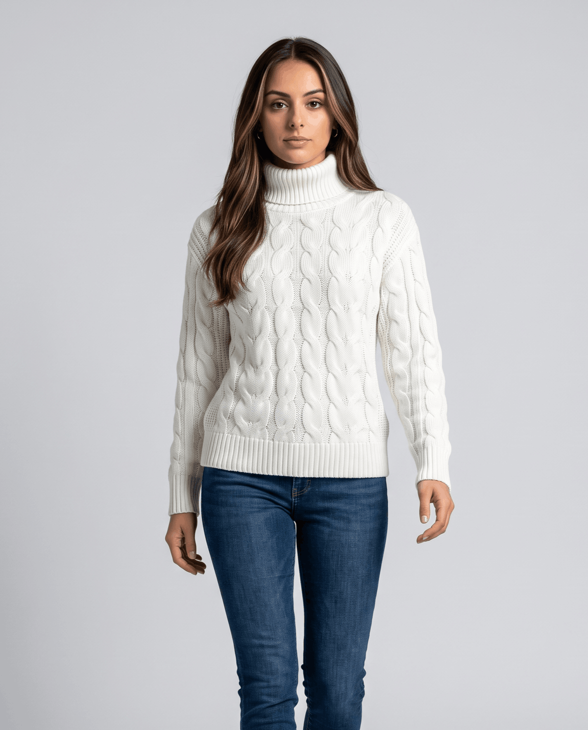 White turtleneck sweater worn with blue jeans, relaxed front view in the studio