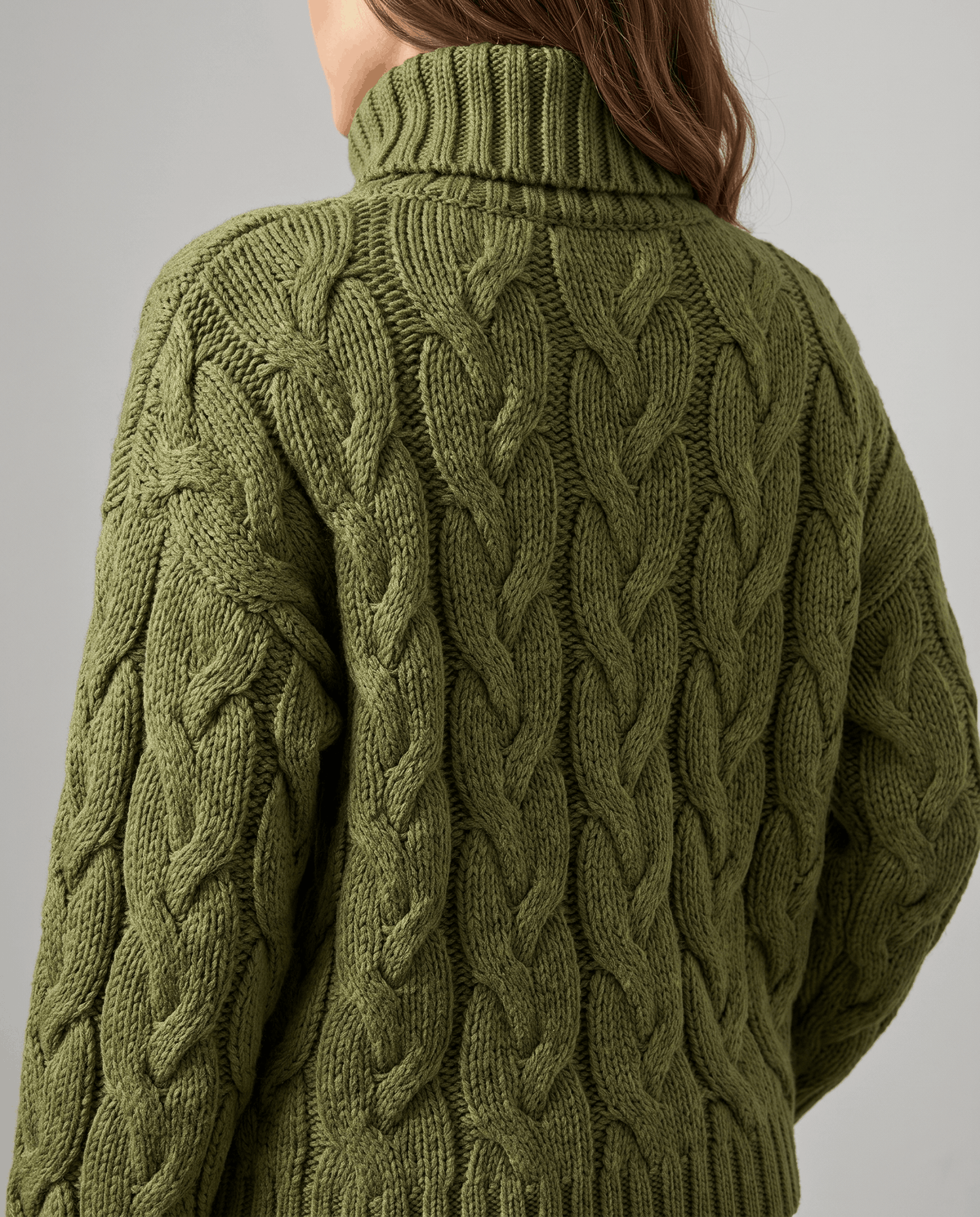 Close view of olive green braided cables and folded turtleneck collar