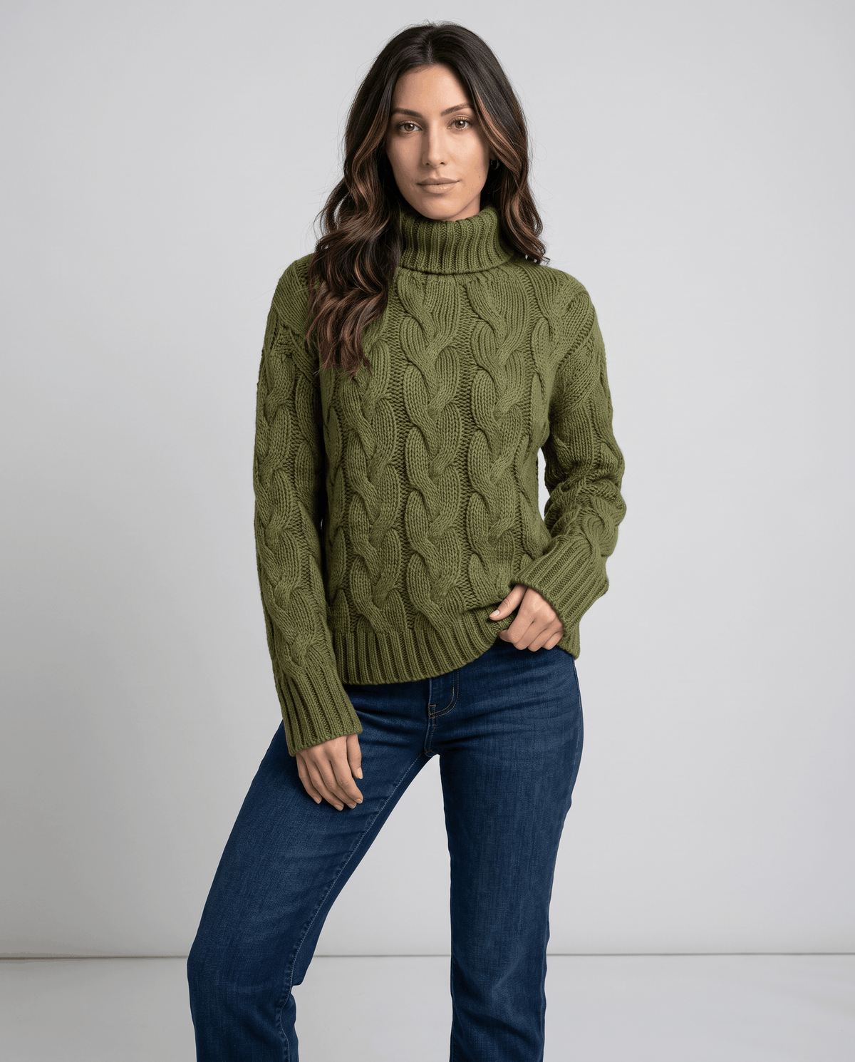 Front view of olive green cable knit turtleneck with medium wash jeans