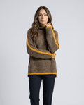 Woman wearing a brown contrast trim turtleneck sweater with navy trousers, hand at collar