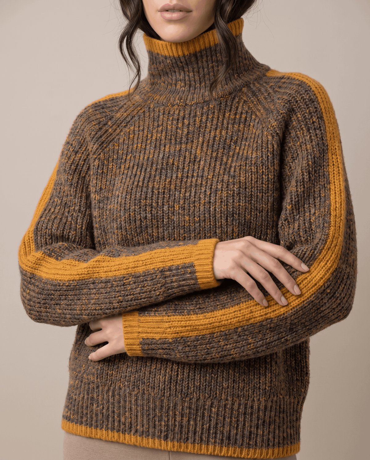 Cropped front view of brown rib knit sweater with mustard sleeve stripes and hem trim