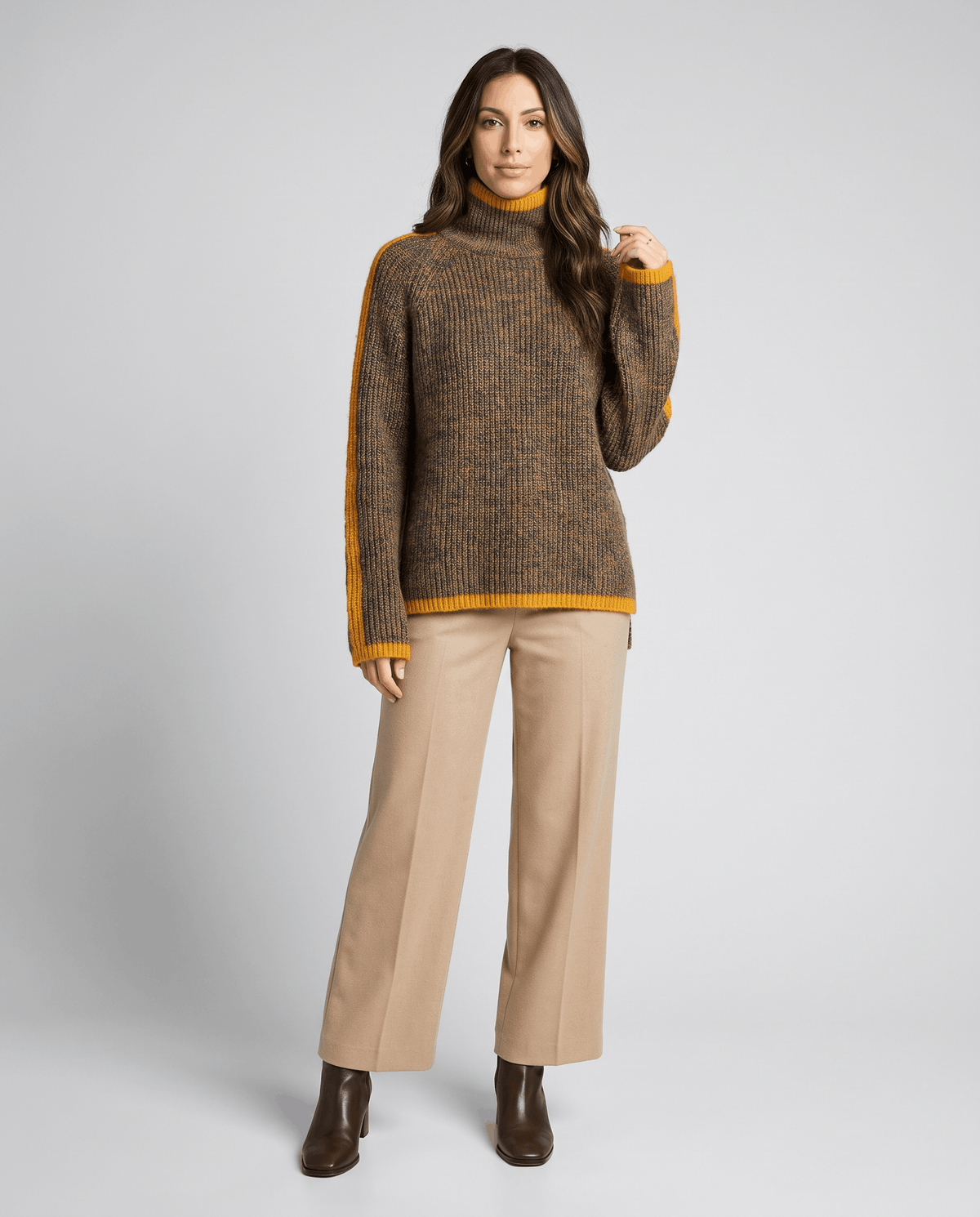 Full-length view of brown turtleneck sweater with tan wide-leg trousers and ankle boots