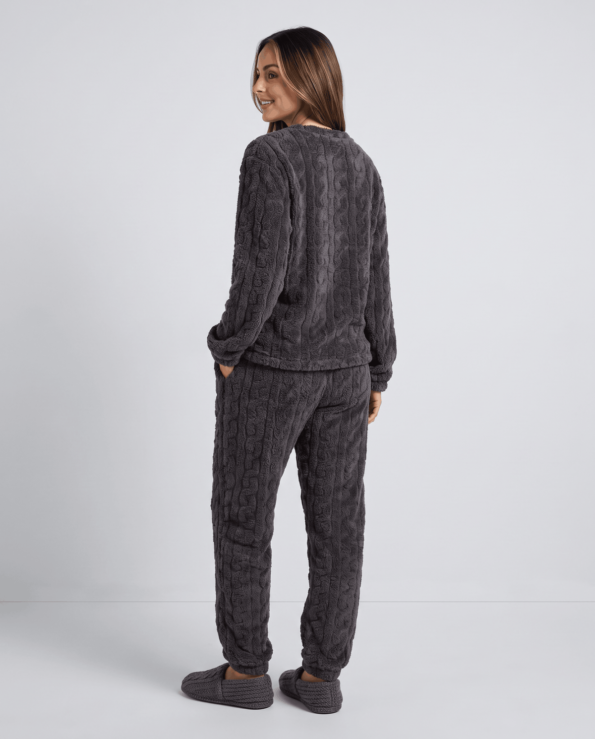 Back view of woman in charcoal plush jacquard top and matching jogger pants