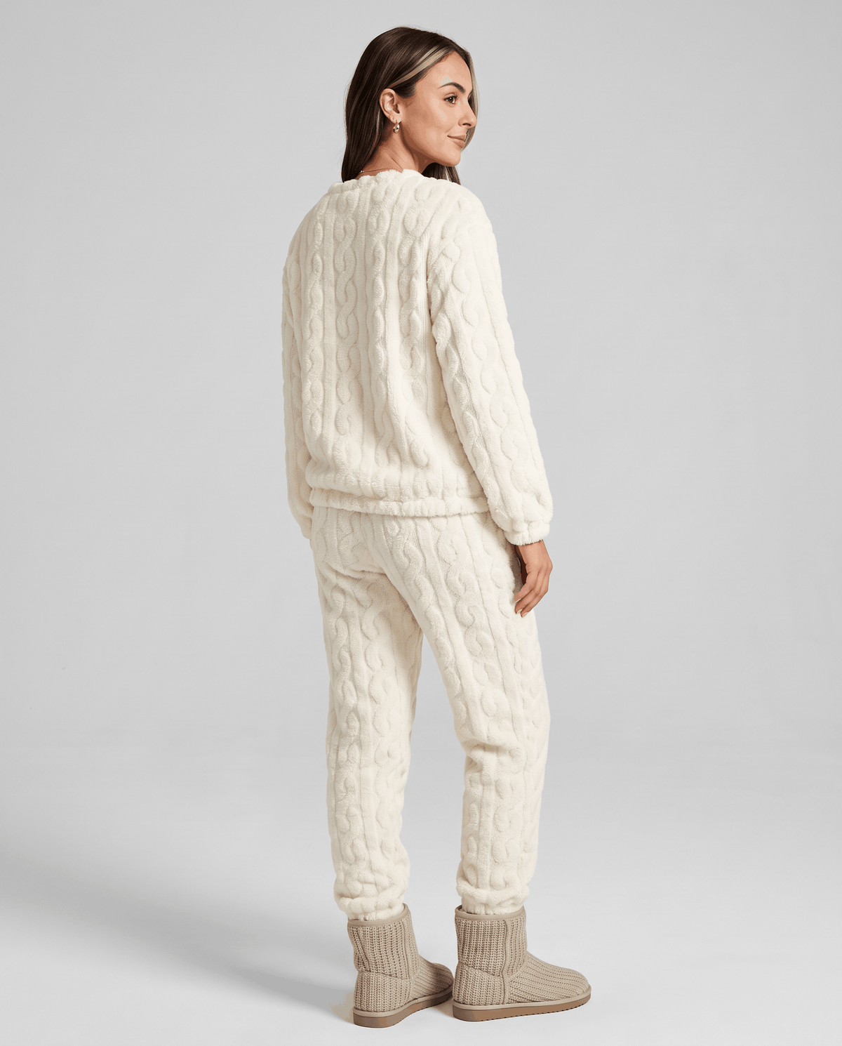 Back view of woman in cream plush jacquard top and matching jogger pants