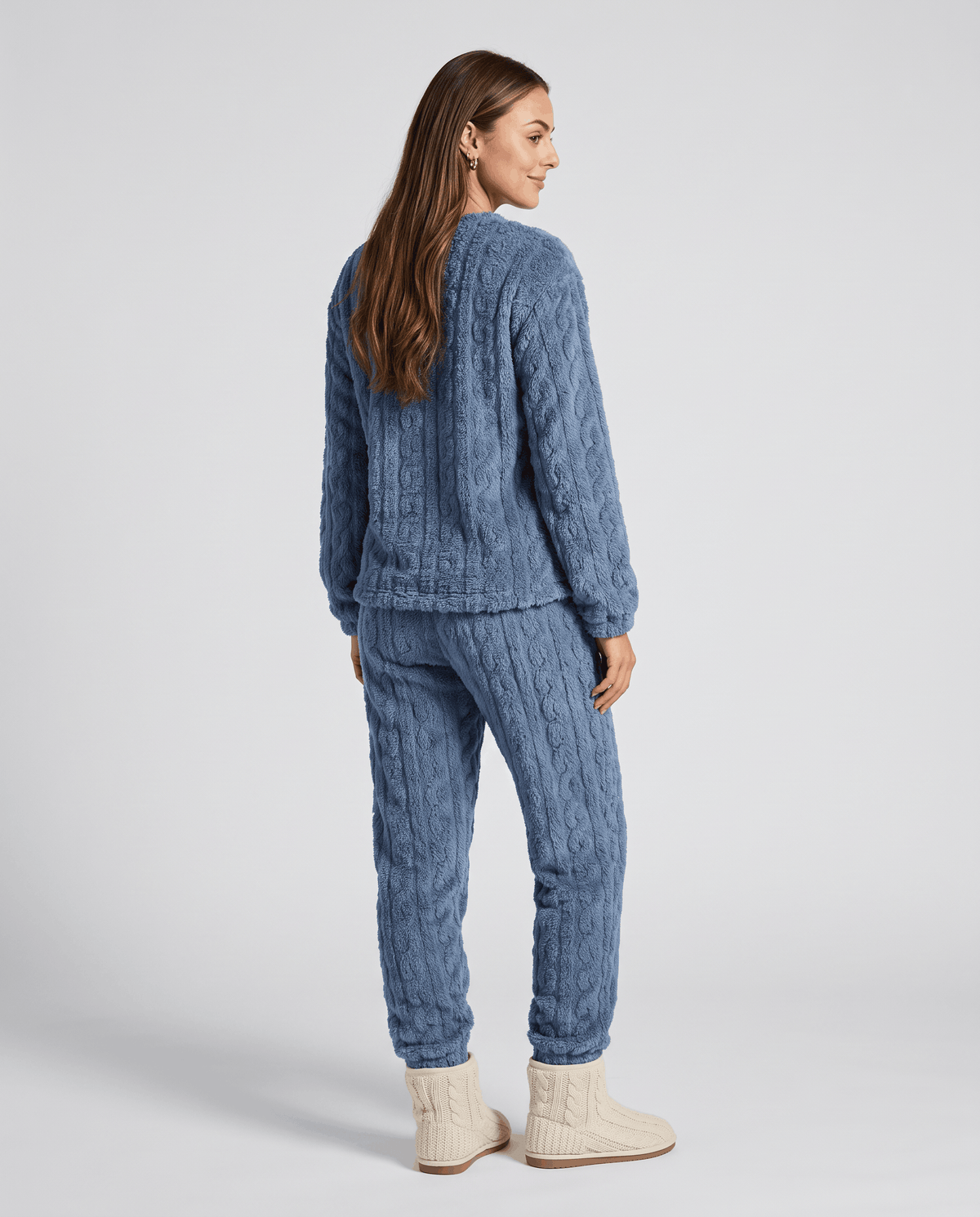 Back view of woman in denim blue plush jacquard top and jogger pants