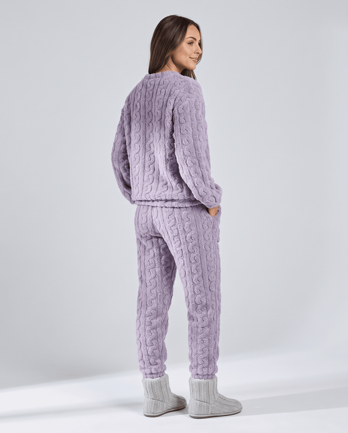 Back view of woman in lavender plush jacquard top and matching jogger pants
