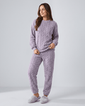 Woman wearing a lavender coral velvet pajama outfit set with jacquard crew neck top and jogger pants