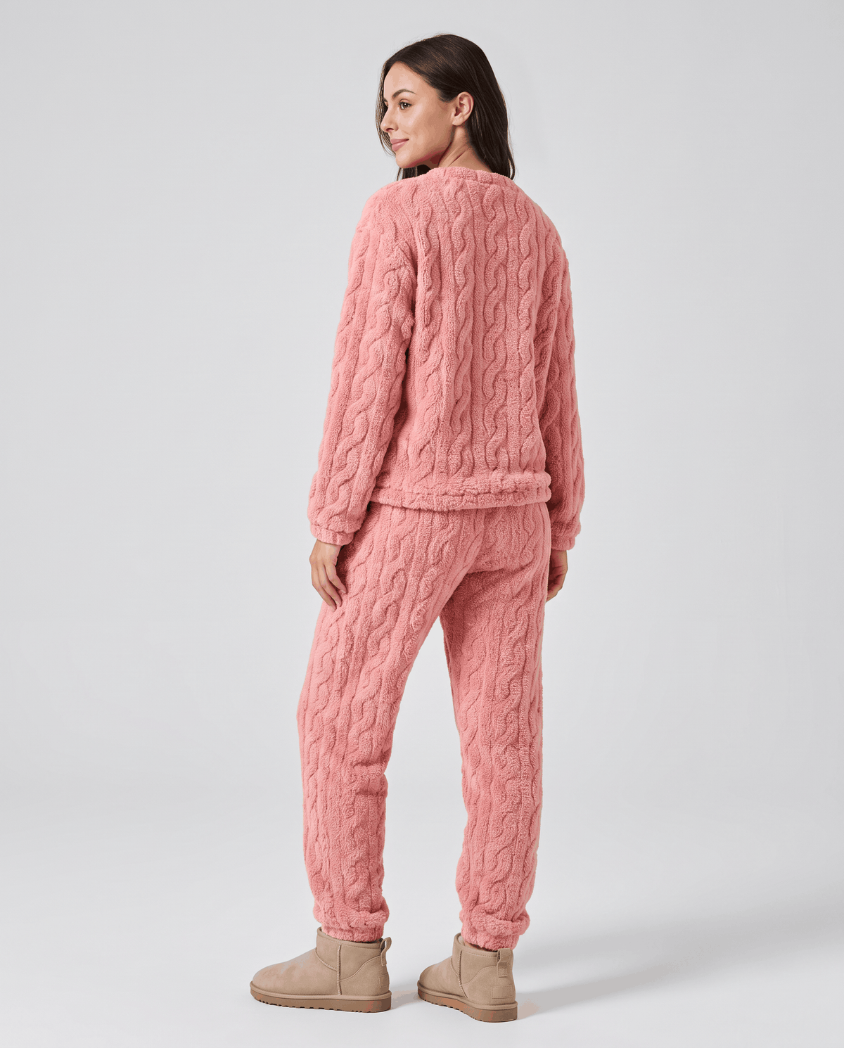 Back view of woman in pink plush jacquard top and matching jogger pants