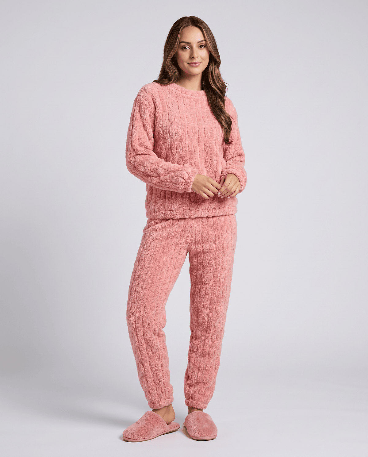 Woman wearing a pink plush jacquard top and matching jogger pants