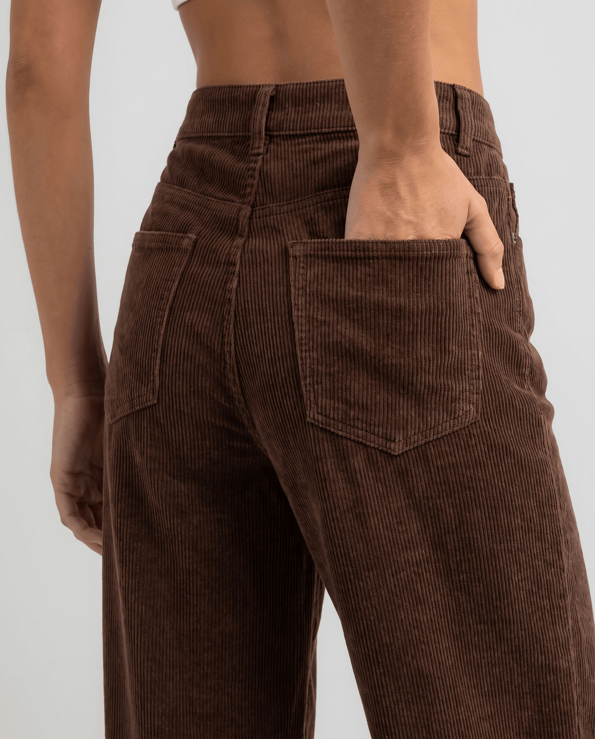 Close-up of a brown back patch pocket on deep ribbed fabric