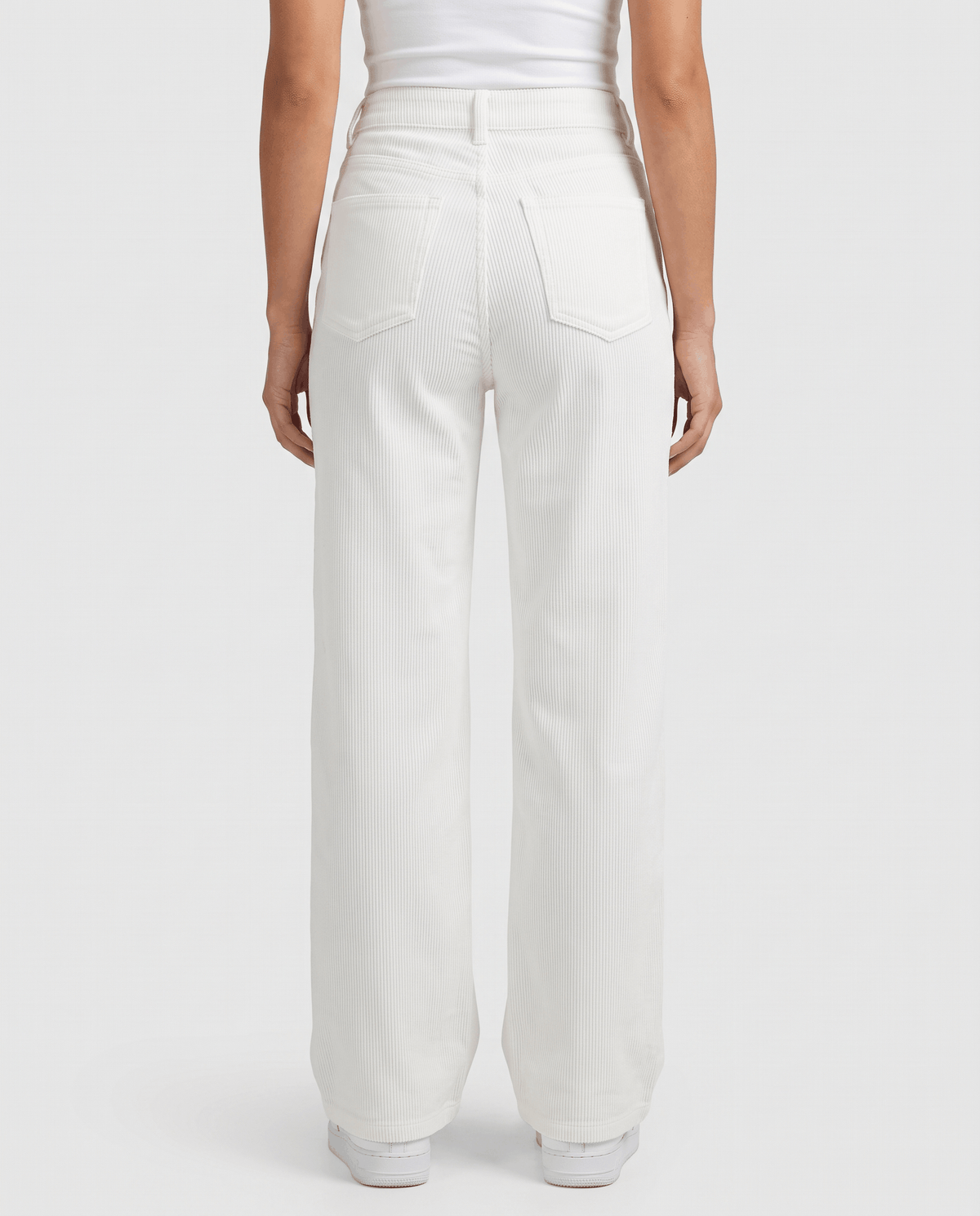Back view of off-white corduroy pants showing the relaxed full-length leg