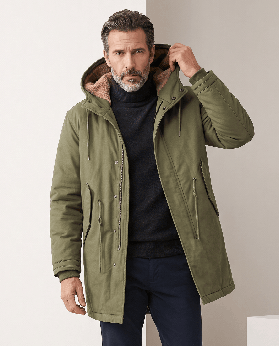 Men's army green cotton hooded parka, front view with hand at the hood