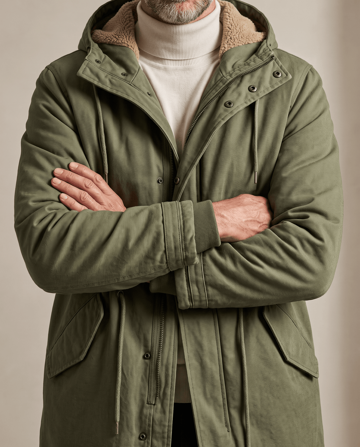 Men's army green cotton hooded parka, flap pockets with arms crossed