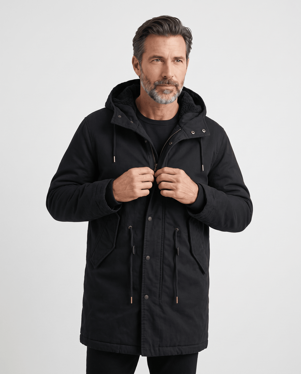 Men's black cotton hooded parka, front view with hands at the zip