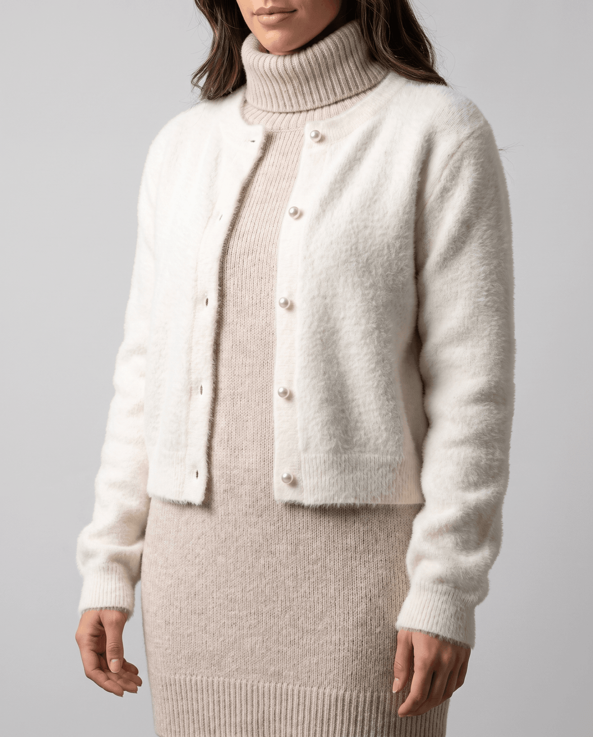 Beige cardigan buttoned over a taupe turtleneck sweater dress