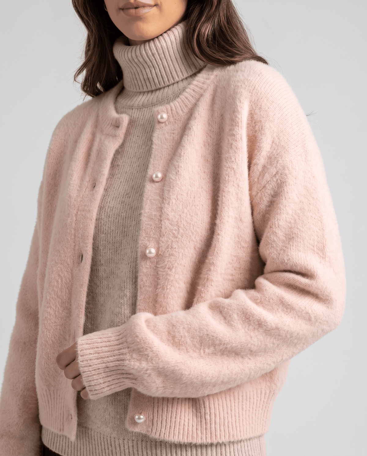 Close-up of the pink cardigan button front and ribbed cuffs