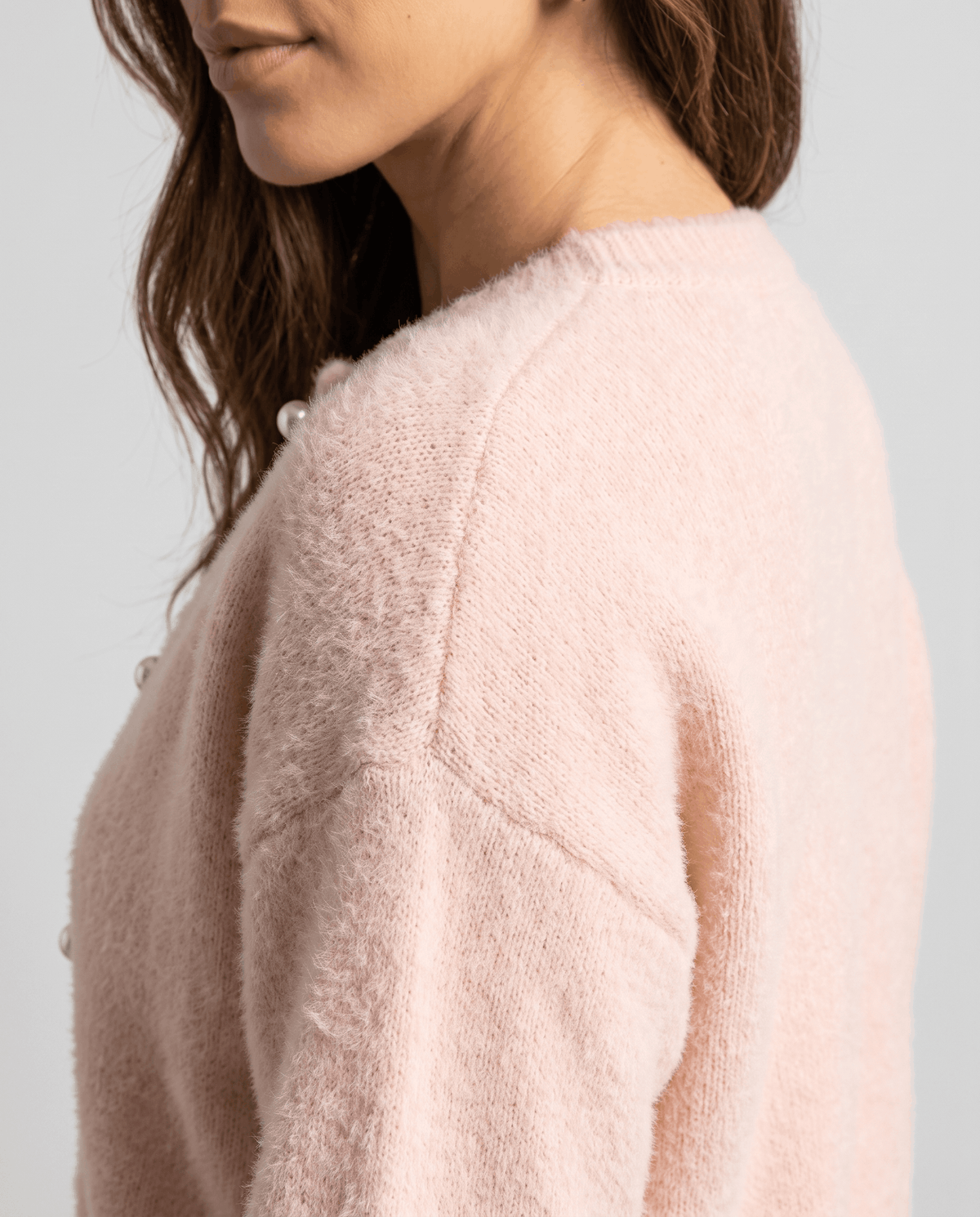 Side detail of the pink plush knit at the shoulder and sleeve