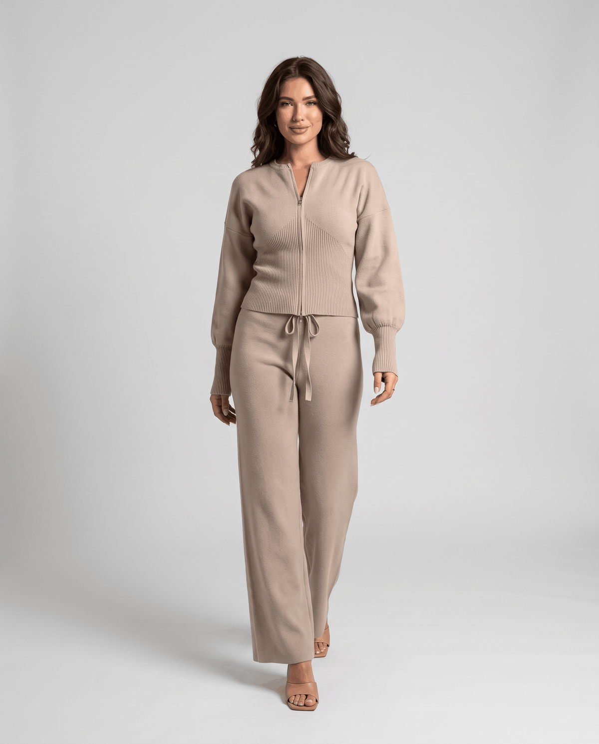 Beige knit loungewear set with a zip-up top and drawstring straight-leg pants, front view