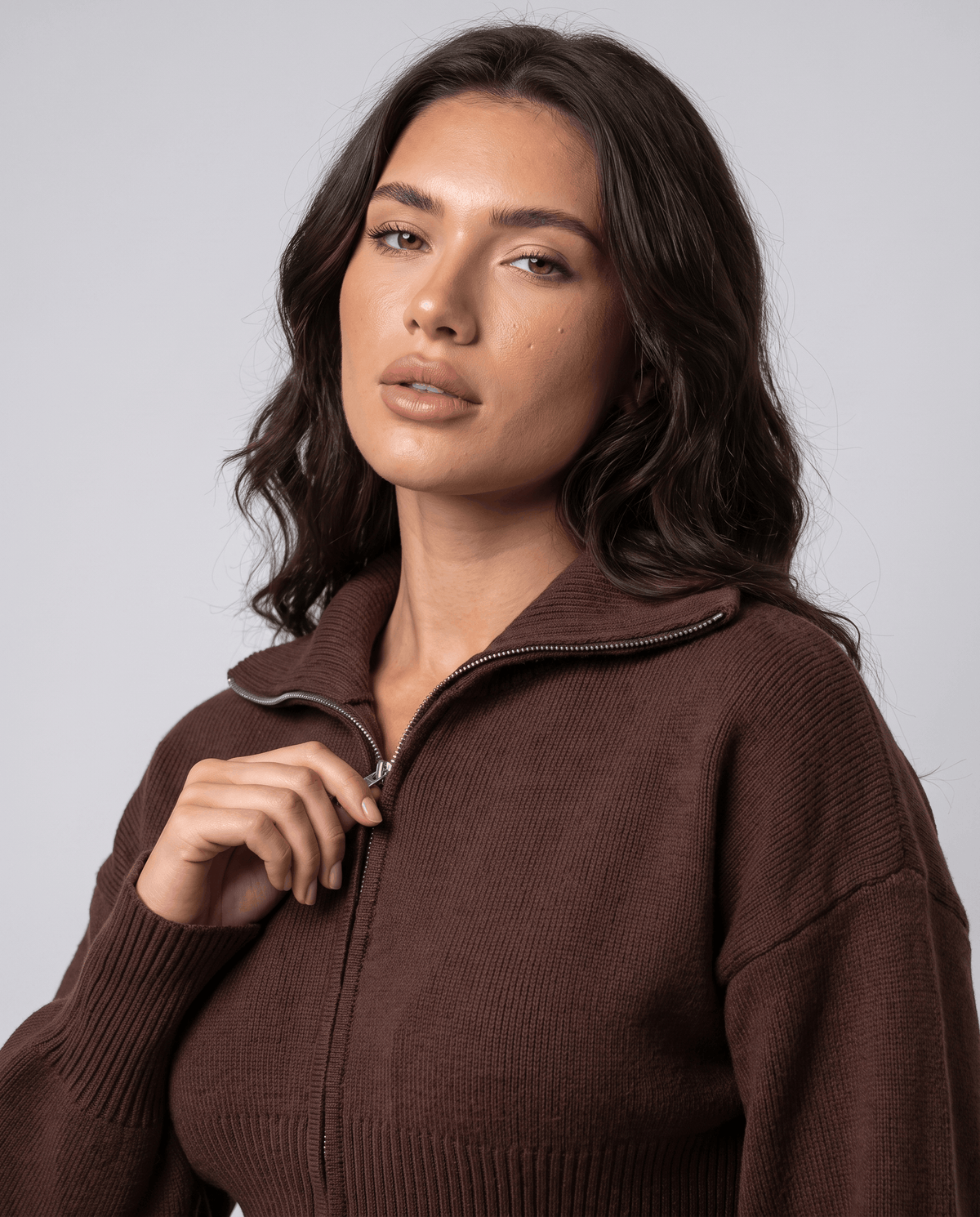 Close-up of the collar and zip on the dark brown knit top