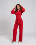 Woman wearing a red knit loungewear set with a cropped zip-up top, balloon sleeves and straight-leg pants, front view