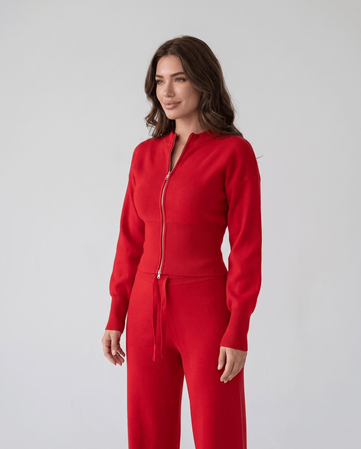 Red zip-up knit top with puffed sleeves and drawstring pants, three-quarter front view